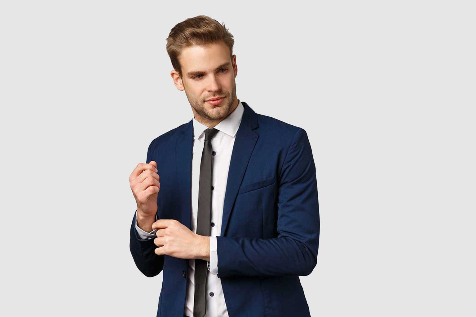 Customer adjusting the cuff of a navy suit jacket tailored to fit