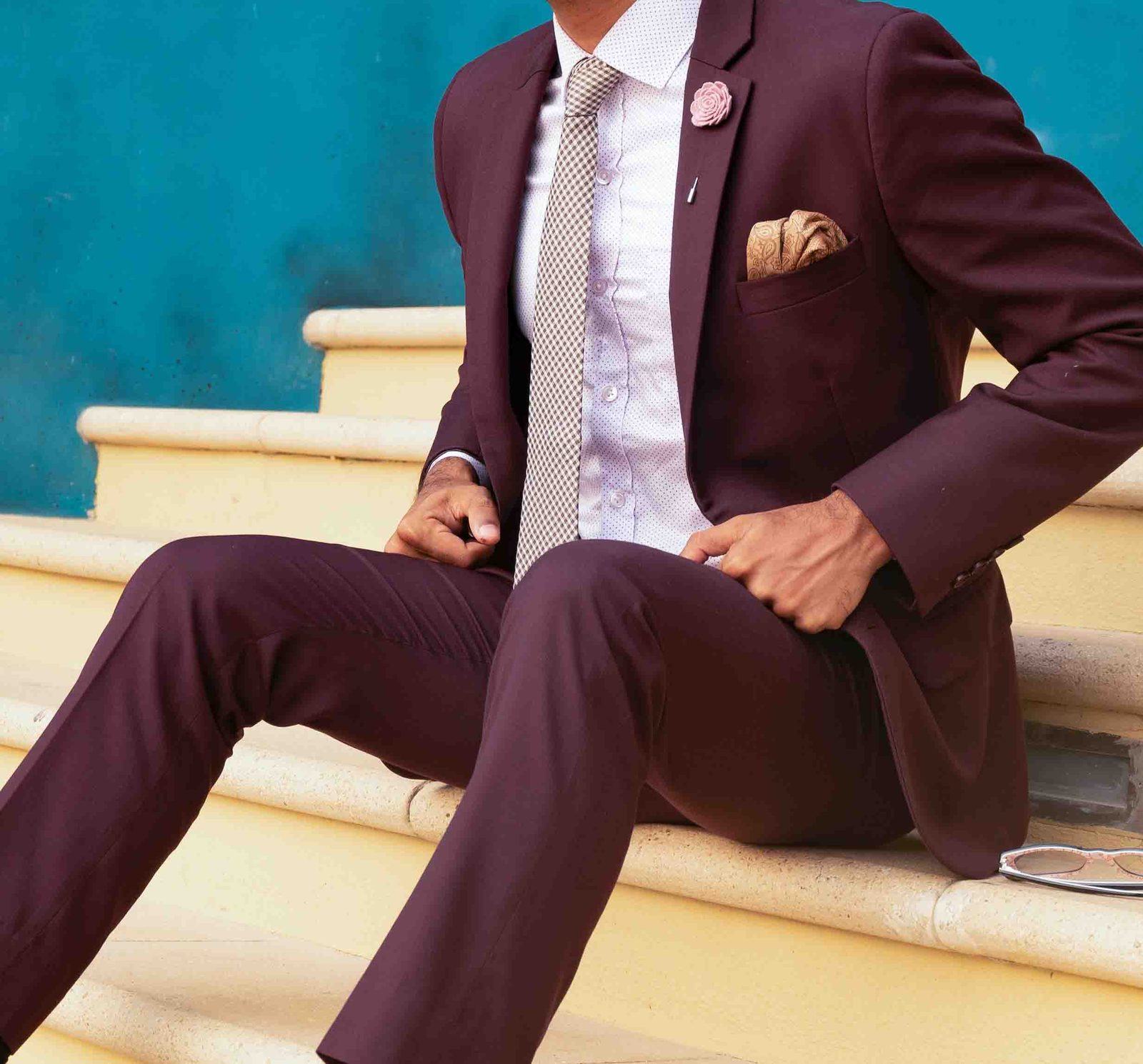 Tailored men's suit jacket being marked for sleeve and waist alterations